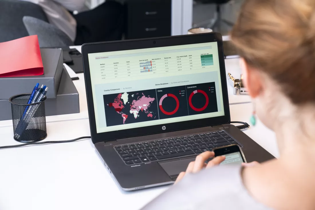 midsection-woman-using-mobile-phone-table